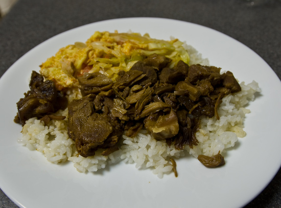 stewed pork, egg with tomatoes, and cabbage over rice