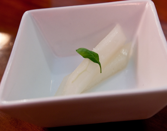 Uchi - amuse bouche of canary melon slices marinated in lime juice with micro-basil