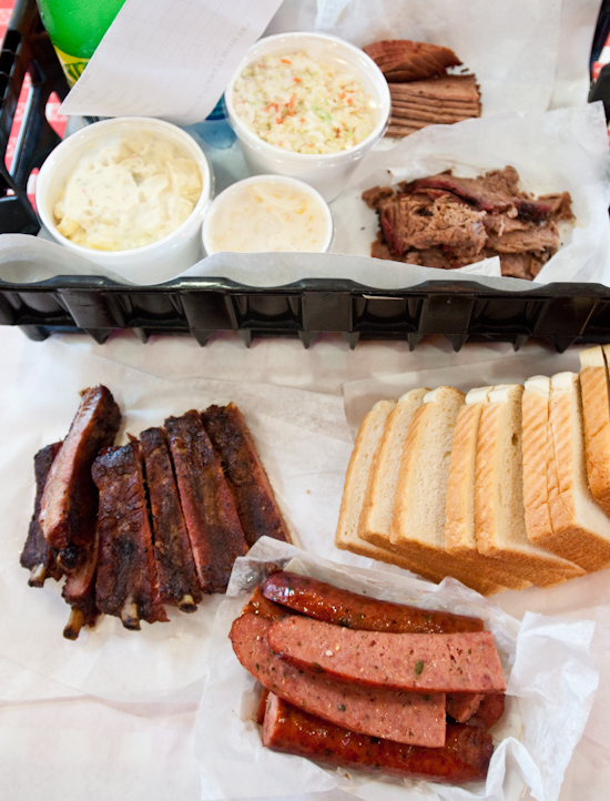 Rudy's BBQ - 1/4 pound lean brisket, 1/2 pound moist brisket, 1 pound ribs, 2 jalapeno sausage links, cole slaw, potato salad, and creamed corn