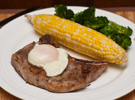 Fried egg on sous vide pork chop, grilled corn, and sauteed broccoli