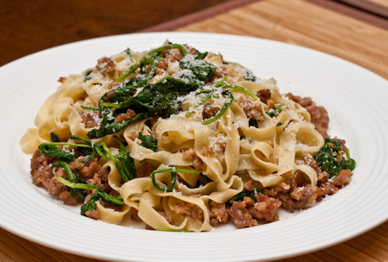 Homemade fresh fettuccine with sausage and arugula