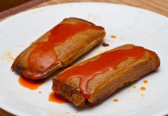 Pork tamales with Cholula hot sauce