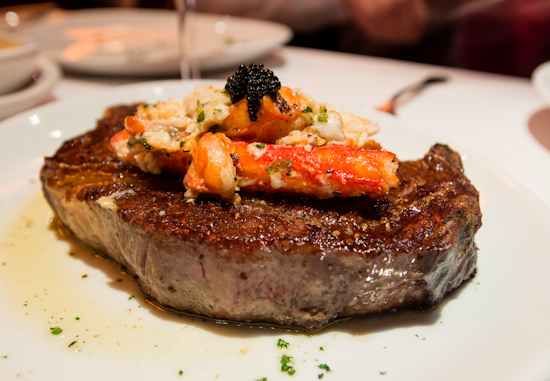 Iron Crusted Dry Aged Prime Ribeye Steak with King Crab with Herb Butter Companion