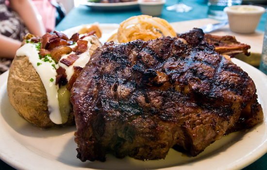 The Backstage Steakhouse - Ribeye Steak with Potato and Onion Rings
