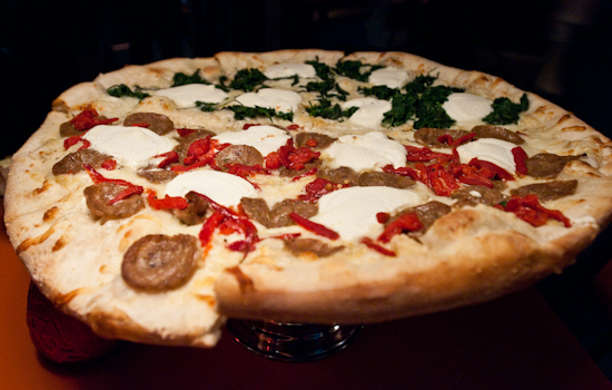 Home Slice Pizza - Large half white pie with spinach and half sausage, ricotta cheese and roasted red pepper pizza